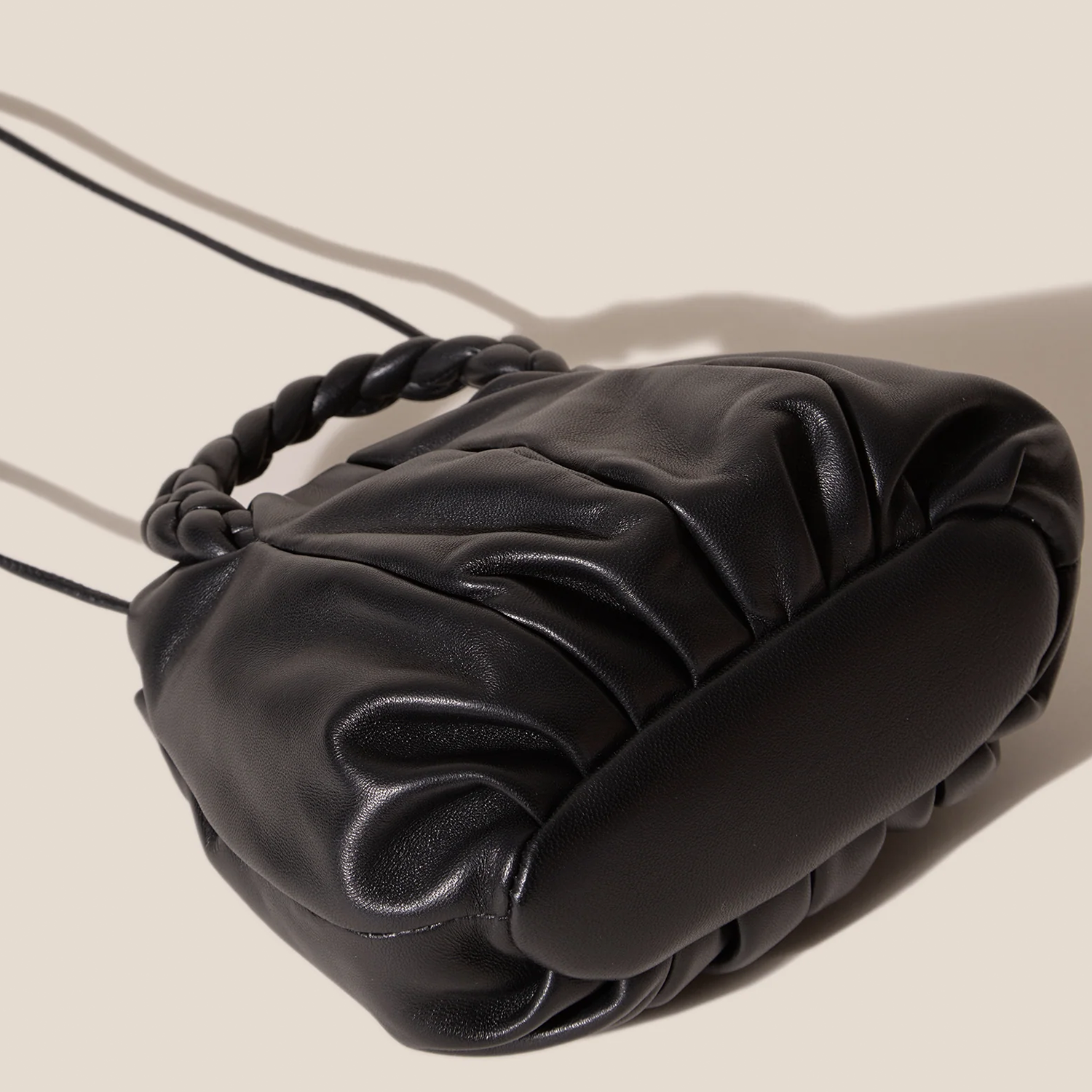 Sleek Jet Black Soft Gathered Petite Rounded Pouch With Thick Woven Braided Loop Grip And Tiny Knotted Closure Tie