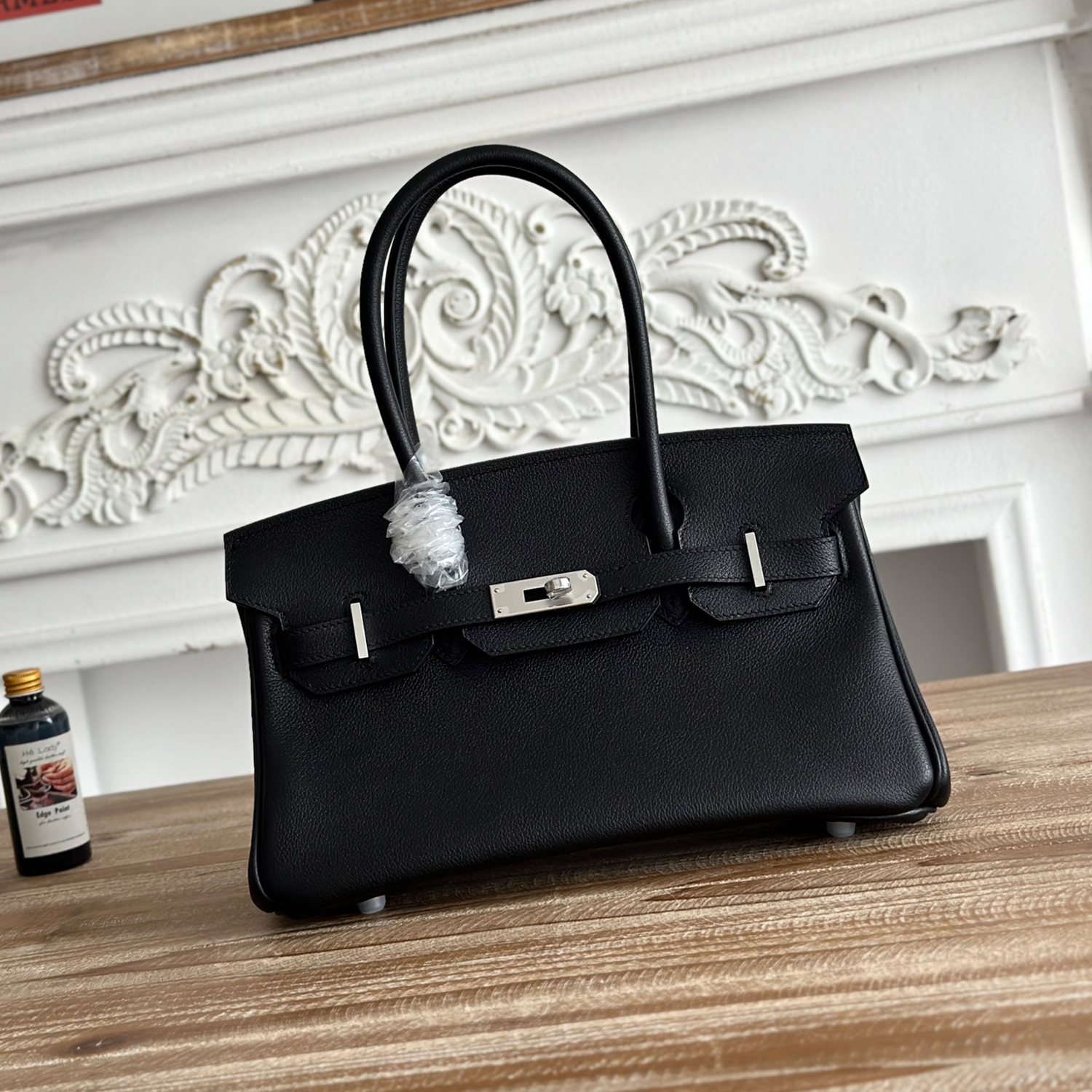 Polished Jet Black Fine Grain Slim Elongated Rectangular Hand Tote With Brushed Silvery Twist Lock Hardware And Dual Curved Top Carry Grips