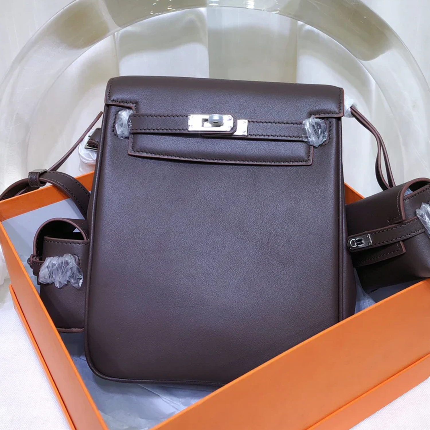 Rich Deep Chocolate Brown Sleek Smooth Compact Vertical Backpack With Pale Contrast Stitching And Polished Silvery Twist Lock Flap Hardware